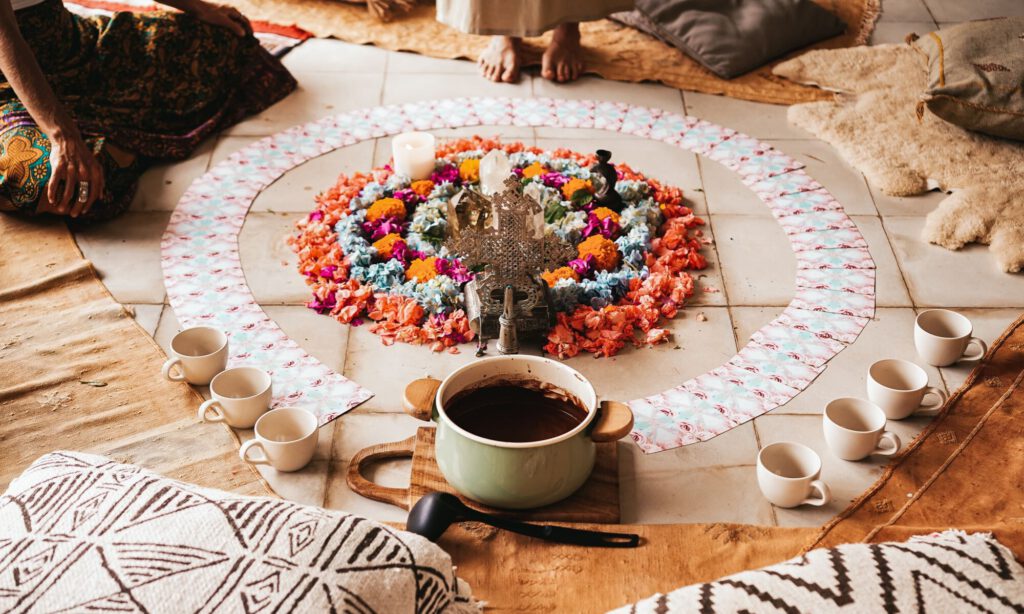 cacao ceremony with cacao pot, flower mandala, and oracle cards